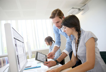 Obraz na płótnie Canvas Business people working in office on desktop computer