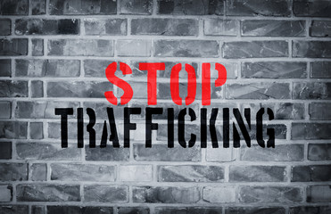 Stop Human trafficking stencil print on the grunge white brick w