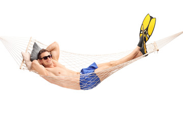 Shirtless young guy lying in a hammock
