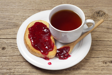 Tea cup and bread with jam