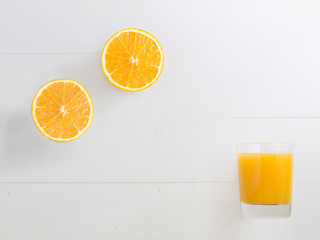 Halved orange and orange juice glass with blank space to write y