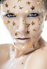 Close up woman portrait with stars on face