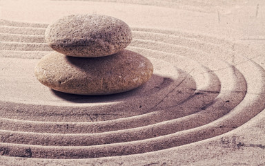 Fototapeta na wymiar zen still life for spa and massage with sand and stones for balance and meditation with textured and contrast effects