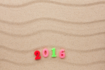 Fototapeta na wymiar New year 2016 written in the san