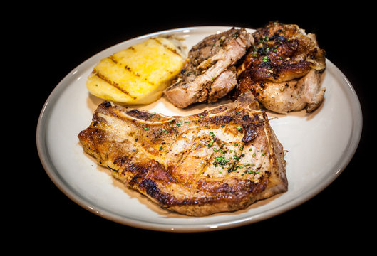 grilled steak in white dish,isolate background,pork chop meat in dish