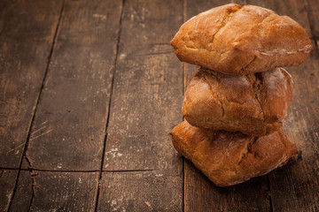 Artisan ciabatta bread over over ancient wooden table