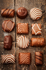 Chocolate pralines over old wooden table
