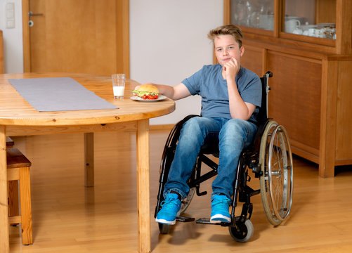 disabled boy in wheelchair is eating