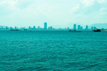 Sae with boat and city on the horizon