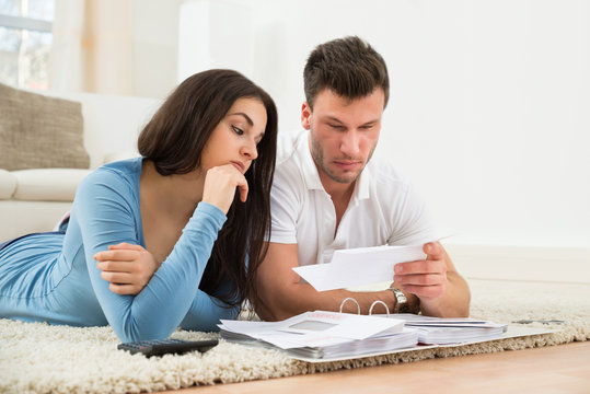 Worried Young Couple Calculating Their Bills At Home