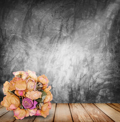 bouquet of rose on wood background with concrete wall