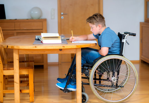 boy in wheelchair doing homework