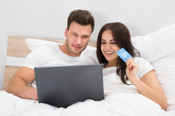 Couple On Bed Shopping Online