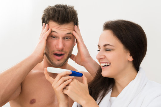 Young Couple Looking At Pregnancy Test