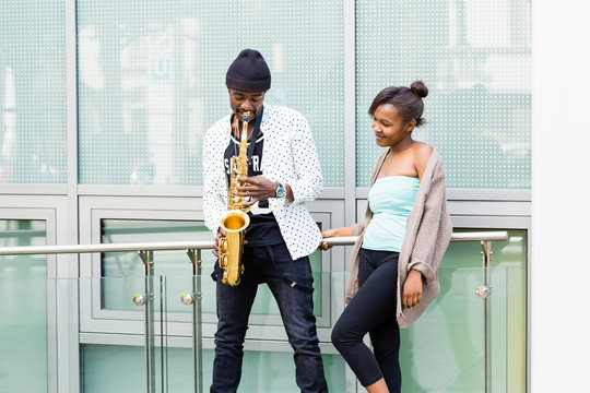 African couple playing Saxophone