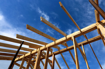 Installation of wooden beams at construction the roof truss syst