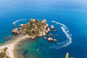 Aerial view of island and Isola Bella beach and blue ocean water in Taormina, Sicily, Italy