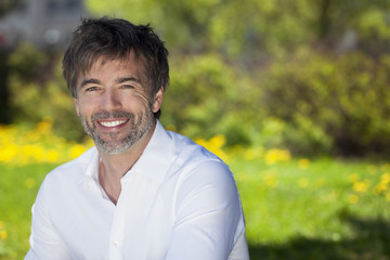 Close-up of a mature man smiling outside