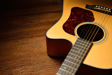 Acoustic guitar on old wooden background