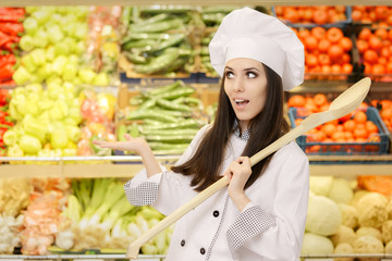 Funny Lady Chef with Big Spoon Presenting Fresh Vegetables