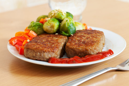 Fast food. Two fried cutlets with vegetables