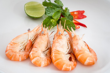 Shrimps and lemon in white plate