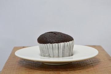 chocolate muffin on wooden board