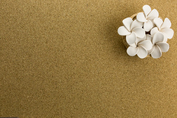 Fototapeta na wymiar ceramic nest with flowers on cork board
