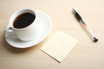 Blank note with ball pen and coffee