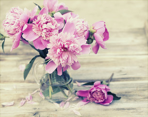 Pink peonies on wooden background - vintage photo