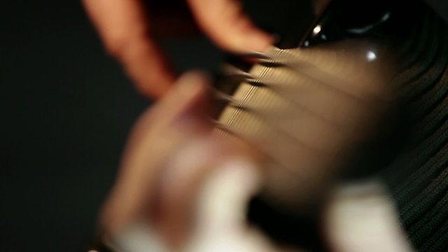 Musician playing bass guitar; closeup, focusing in