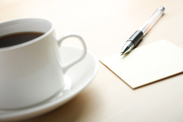 Blank note with ball pen and coffee