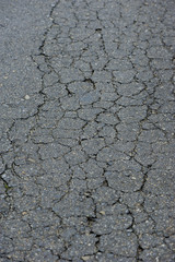 Macro closeup on concrete asphalt cracks on the road