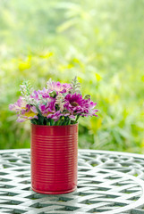 beautiful fake flowers in tin vase the decoration on table at outdoor garden