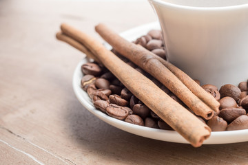 cup of coffee with cinnamon and beans