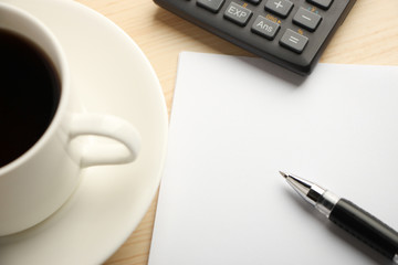 White paper calculator and coffee