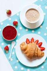 Traditional croissant French sweet dessert with a cup of coffee