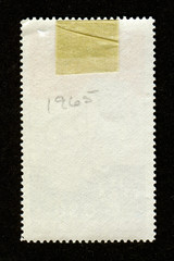 Reverse side of a postage stamp.