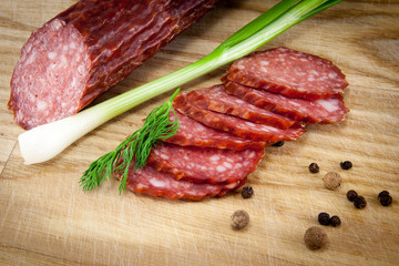 salami sausages on wooden board isolated