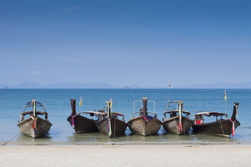 Beautiful long tails boats on blue andaman sea background near Krabi