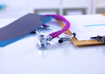 Doctor&amp;amp;#39;s stethoscope  with folder on the desk