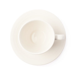 White ceramic cup on a plate isolated