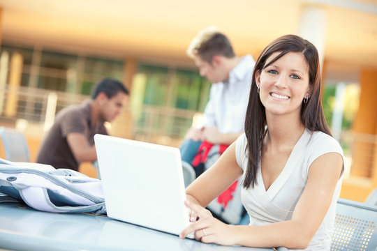 College: Smiling Female Student Studying Outdoors With Laptop