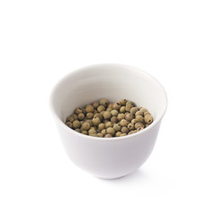 Green peppercorn in a cup isolated