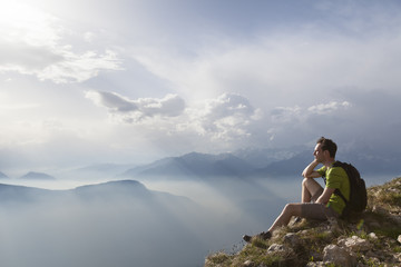 Hiker sitting to view beautiful landscape