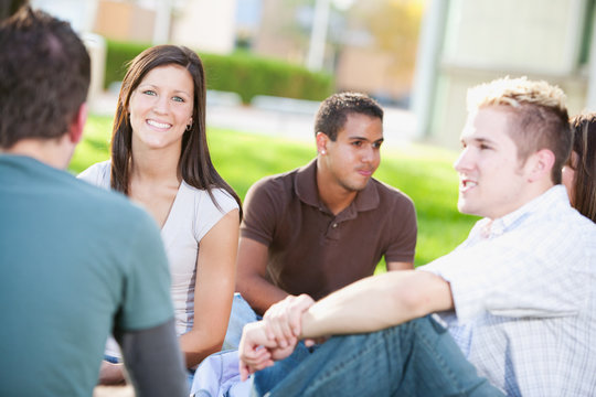 College: Girl Sitting with Friends on Campus