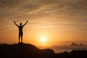 Happy winning successful man raising hands