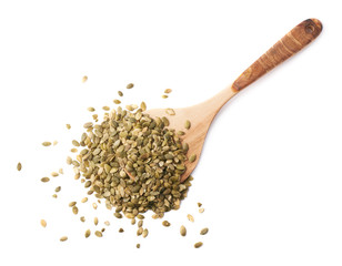 Wooden spoon covered with pumpkin seeds