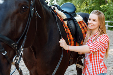 Obraz premium Girl standing near the horse 