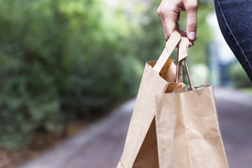 Woman holding paper bags after food shopping
